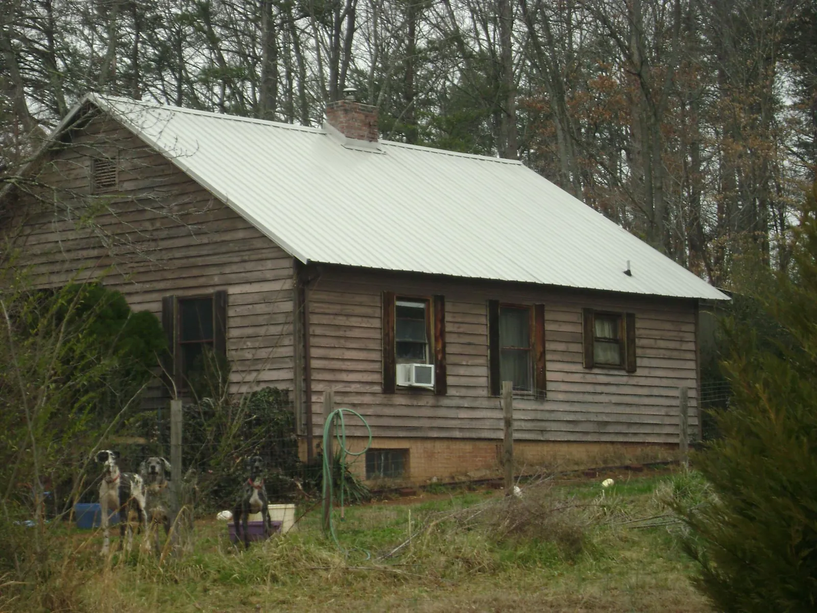 White metal roof on an old wood sided farmhouse, from a Metal Roof Installation job in Effingham